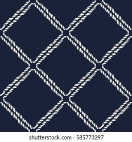 Seamless nautical rope pattern. Endless navy illustration with white cord ornament on dark blue backdrop. Trendy maritime style background. For fabric, wallpaper, wrapping