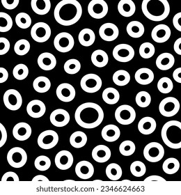 Seamless neutral rings pattern. White hand-drawn oval isolated on black background. Doodle dots cozy ornament. Vector illustrations with circles for wallpaper, posters, wrapping paper, textile, fabric