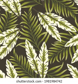 Seamless original tropical pattern with bright colorful plants and leaves on a dark green background. Modern abstract design for fabric, paper, interior decor. Tropic leaves in bright colors.