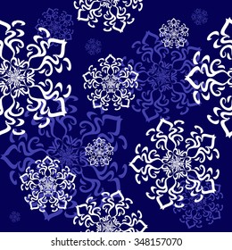 Seamless ornament with a decorative snowflakes in abstract style