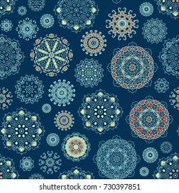 Seamless ornamental vector pattern with decorative rosettes on  blue background
