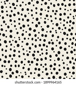 Seamless pattern of abstract animal background. Hand-drawn trendy cheetah pattern isolated on beige background. Suitable for web and print design. Asymmetrical texture of different sizes of ovals.