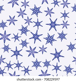 Seamless pattern with abstract colorful snowflakes on light blue background. Chaotic, random, scattered winter motives. Vector illustration.