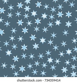 Seamless pattern with abstract colorful snowflakes on blue background. Chaotic, random, scattered winter motives. Vector illustration.