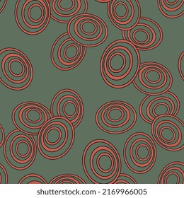 Seamless pattern with abstract ellipse shapes and spiral motifs. Red and green ovals on green background.