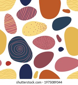 Seamless pattern with Abstract geometrical shapes. Various shapes similar to sea stones In trend colors. For wallpaper, textile, packaging, wrapping. Abstract contemporary modern vector illustration