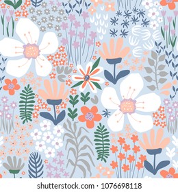 Seamless pattern with abstract hand-drawn flowers and plants on a light blue background in a vector.