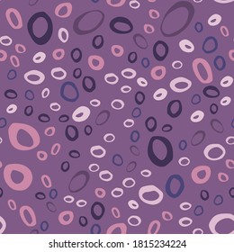 Seamless pattern with abstract rings ornament. Random located doodle geometric circle shapes in purple palette. Great for wallpaper, textile, wrapping paper, fabric print. Vector illustration.
