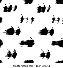 Seamless pattern from abstract short textured black brush strokes on a white background