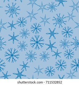 Seamless pattern with abstract snowflakes on blue background. Chaotic, random, scattered winter motives. Vector illustration.