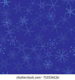 Seamless pattern with abstract snowflakes on blue background. Chaotic, random, scattered winter motives. Vector illustration.