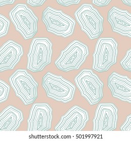 Seamless pattern with agate stones slices in soft pastel green on light pink background. Vector stock illustration. EPS 8.