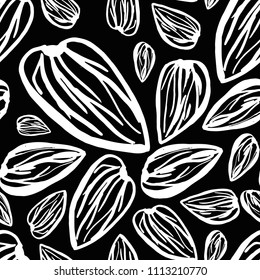 Seamless pattern with almonds on the black background. Cute simple sketch template.