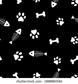 Seamless pattern of animals paws, bones and fish skeleton. Vector illustration on a black background.