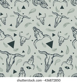 Seamless pattern with animals skulls, feathers and triangles. 
Triangles, skulls and feathers dark grey in a chaotic manner.