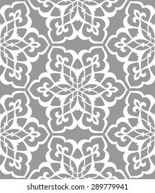 Seamless pattern in Arabic style. Intersecting curved elegant lines and scrolls forming abstract floral ornament. Arabesque.