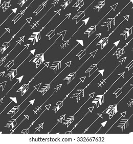 Seamless pattern with arrows on a black background. Hand drawn doodle. Vector illustration