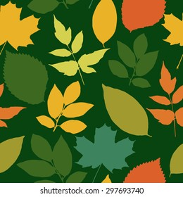 Seamless pattern with autumn bright leaves on a green background.  Vector illustration