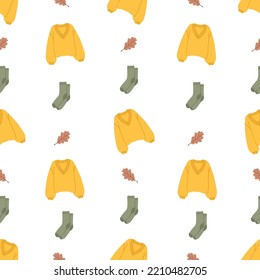 Seamless pattern with autumn clothes. Sweater, socks, leaf. Creative seasonal fall clothes. Template for posters, flyers, postcards. Colorful vector illustration in flat cartoon style
