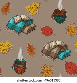 seamless pattern with autumn leaves, a cup of tea and a warm blanket with book