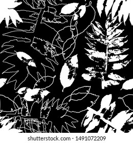 Seamless pattern of autumn leaves on a dark background. Vector illustration of a leaf imprint.