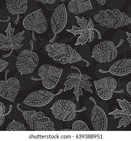 Seamless pattern with autumn leaves painted against a dark background