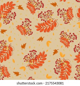 Seamless pattern with autumn leaves  and rowan berries on beije background. For textile, giftpaper, wallpaper.