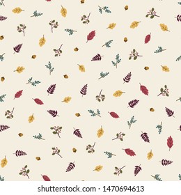 Seamless pattern of autumn leaves, twigs, berries and acorns.
