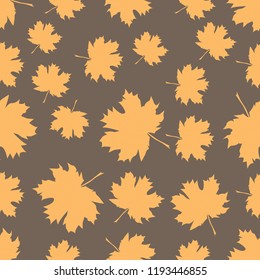 Seamless pattern with autumn maple leaves. Golden yellow leaves on light brown background. Vector illustration