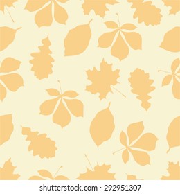 Seamless pattern with autumn motifs. The leaves of different trees on orange-peach background.