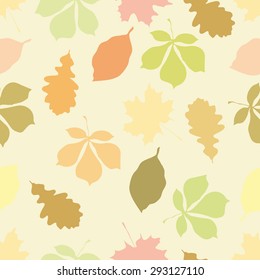 Seamless pattern with autumn motifs. The leaves of different trees on a pale peach background.