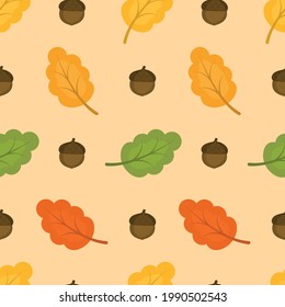 Seamless pattern with autumn oak leaves and acorns. Light orange background. Vector illustration.