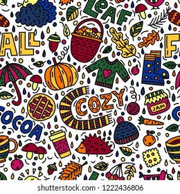 Seamless pattern with autumn symbols in doodle style with lettering