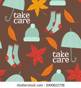 Seamless pattern with autumn vibes -warm socks, hat and umbrella, white text - Take care, falling leaves on brown background