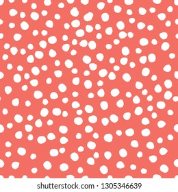 Seamless pattern background. Coral colour, endless hand drawing abstract doodle of dots or circles, ovals, bubbles or snow, this year. Vector.