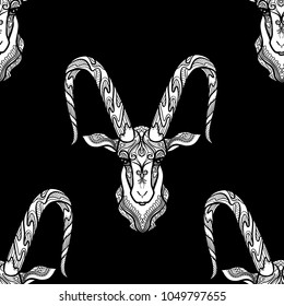 Seamless pattern, background with ethnic patterned ornate hand drawn head of Capricorn, goat white on black background . 