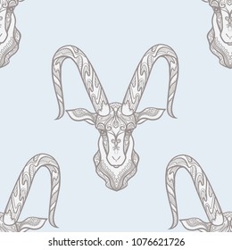 Seamless pattern, background with ethnic patterned ornate hand drawn head of Capricorn, goat. On blue vintage  background. 