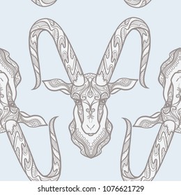 Seamless pattern, background with ethnic patterned ornate hand drawn head of Capricorn, goat. On blue vintage  background. 