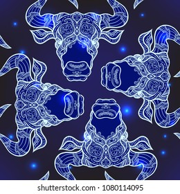 Seamless pattern, background with ethnic patterned ornate hand drawn head of Taurus, bull, ox .  On dark blue spase background with stars. 