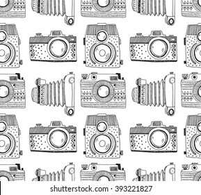 Seamless pattern background with hand drawn ornamental retro cameras. Vector illustration.