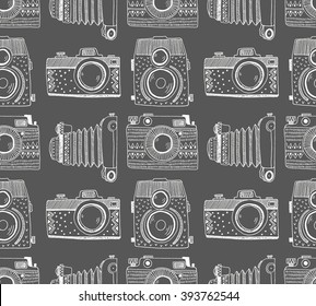 Seamless pattern background with hand drawn ornamental retro cameras. Vector illustration.