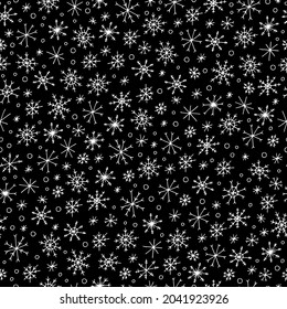 Seamless pattern. Background. White snowflakes on a black background. Snowfall. New Year. Christmas. Winter Holidays.Vector. Doodle. Hand-drawn illustration.