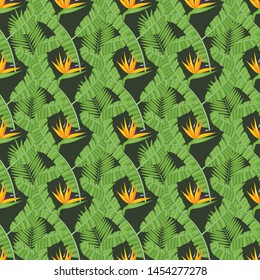 Seamless pattern with banana and areca palm leaves and bird of paradise flowers.