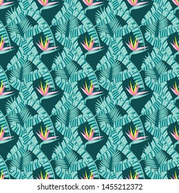 Seamless pattern with banana and areca palm leaves and bird of paradise flowers.