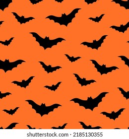 Seamless pattern bat silhouettes on orange background vector illustration