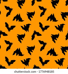 Seamless pattern of bats.Silhouette of black bats on an orange background. Design for Halloween. Flat vector illustration