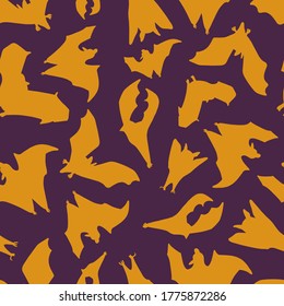 Seamless pattern of bats.Silhouette of orange bats on a purple background. Design for Halloween. Vector illustration