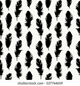 Seamless pattern with beautiful black feathers on white. Vector background.