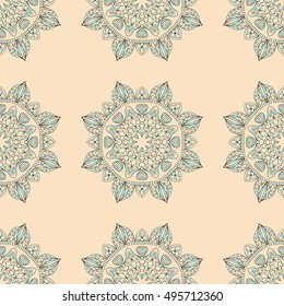Seamless pattern with beautiful blue mandalas on the light pink background. Vector background