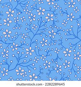Seamless pattern of beige flowers and blue contour branches. On a blue background.
